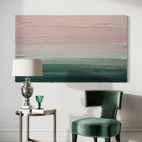 A light Coral, light pink, celadon and hunter green thickly textured abstract painting by Teodora Guererra hanging on a white wall over a green velvet chai with an end table and lamp to the side.