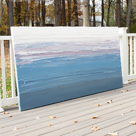 A blue, light pink, coral and white thickly textured abstract painting leaning on a deck outside in natural light by Teodora Guererra.