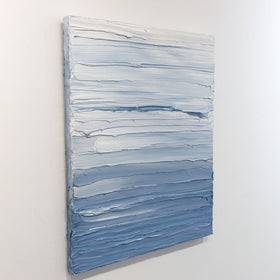 A painting is shown hanging on the wall at an angle. Its surface is decorated with blue and white paint in thick impasto streaks. Wired and ready to hang.