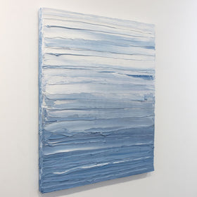 A painting is shown hanging on the wall at an angle. Its surface is decorated with blue and white paint in thick impasto streaks. Wired and ready to hang.