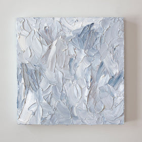 A painting is hanging on a wall. Its surface is decorated with white, blue and grey paint in a thick impasto. Wired and ready to hang