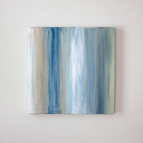 A blue, white, green and tan streaked painting hangs on a wall. Wired and ready to hang.