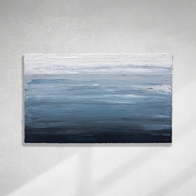 A dark navy blue, light blue, blue, and white thickly textured abstract painting hanging on a white wall in natural light by Teodora Guererra.