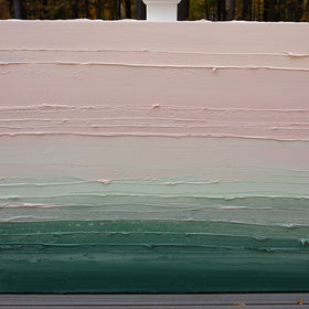 A light Coral, light pink, celadon and hunter green thickly textured abstract painting by Teodora Guererra leaning outside on a deck.