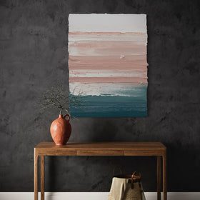 Abstract painting on a dark wall above a wooden table with decorative items.