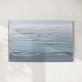 A white, teal and grey heavily textured abstract painting like sculpture by Teodora Guererra hangs on a white wall in natural light.