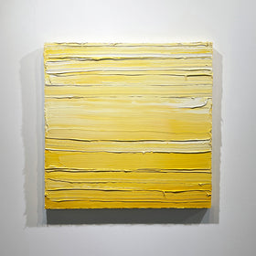 A yellow and white textured abstract painting by Teodora Guererra hangs on a white wall.