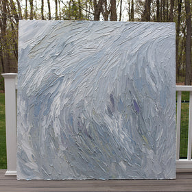A Grey blue, light blue, lavender, celadon and white thickly textured abstract painting leaning on a deck outside in natural light by Teodora Guererra.