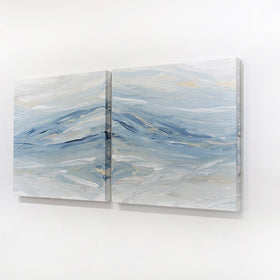 A pair of coastal paintings with blue, grey, white, cream, stone, teal, and yellow ochre paint hanging on a white wall, side view, by Teodora Guererra.