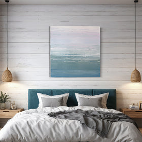 A teal blue, teal green, lavender and pale lavender textured abstract painting by Teodora Guererra hangs on a wall above a queen bed with a teal velvet headboard. White and grey bed linens dress the bed and 2 wicker lamps hang on either side. 