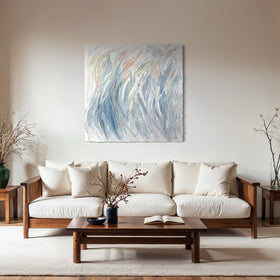 Living room with a white sofa, wooden coffee table, and original abstract painting on the wall.