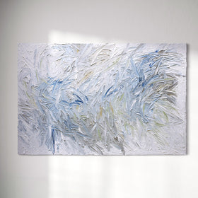 Original abstract painting by Teo Guererra with very textured blue and white brushstrokes hanging on a white sunlit wall.
