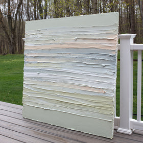 A peach, grey, white, celadon and sage green thickly textured painting leaning outside on a deck in natural light by Teodora Guererra.