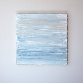 An abstract painting with thick impasto brushstrokes of blue, white, teal, and hints of orange paint is hung on a gallery wall.