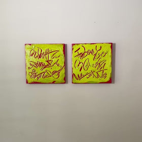 A video of two square abstract text-based paintings with textured chartreuse over hot raspberry pink  graffiti-style lettering, displayed side-by-side on a white wall.