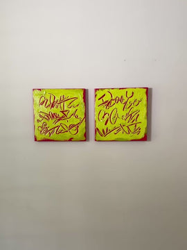 A video of two square abstract text-based paintings with textured chartreuse over hot raspberry pink  graffiti-style lettering, displayed side-by-side on a white wall.
