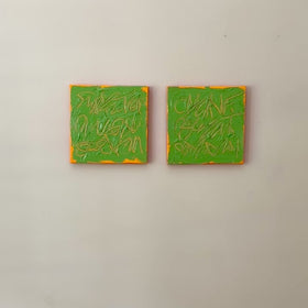 a video of two square abstract text based paintings with thick green paint and tangerine gestural lines, hanging on a white wall.