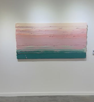 A video of a peach, orange, coral, pale pink and teal thickly textured abstract painting hangs on a white wall.