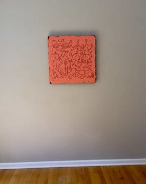 A video of a square abstract painting with a textured coral-pink surface and dark calligraphic line work, mounted against a light gray wall.