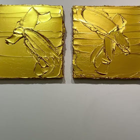 A video of a pair of golden textured paintings by Teodora Guererra hanging on a gallery wall.