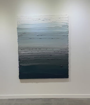 A video of a dark grey blue, light blue, blue green, and white thickly textured abstract painting hanging on a white wall in natural light by Teodora Guererra.