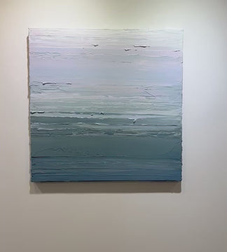 A video of a teal blue, teal green, lavender and pale lavender textured abstract painting by Teodora Guererra hangs on a white wall.