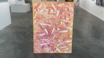 A video of an orange, pink, coral and white thickly textured abstract oil painting leaning in the gallery by the open door.