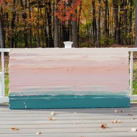 A peach, coral, pale pink and teal thick textured painting leaning outside on a deck in natural light by Teodora Guererra.