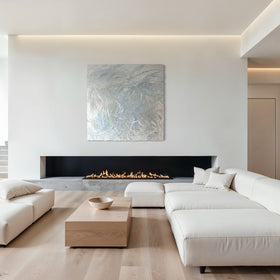 Modern living room with white sectional sofa, coffee table, featuring an original abstract painting by Teodora Guererra.