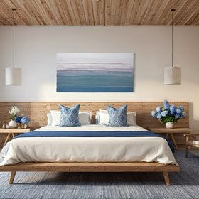 Modern bedroom with wooden bed, blue accents, and ocean view featuring n original abstract painting by Teo Guererra.