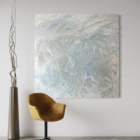 An original abstract painting by Teo Guererra on a wall with a gold chair and decorative vase in a room.