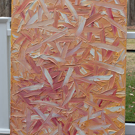 A orange, pink, coral and white textured abstract painting sits on the artists deck.