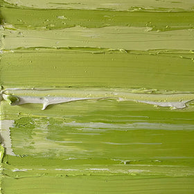 A close up detail of the thick paint texture a chartreuse green and white abstract painting by Teodora Guererra on a white wall.